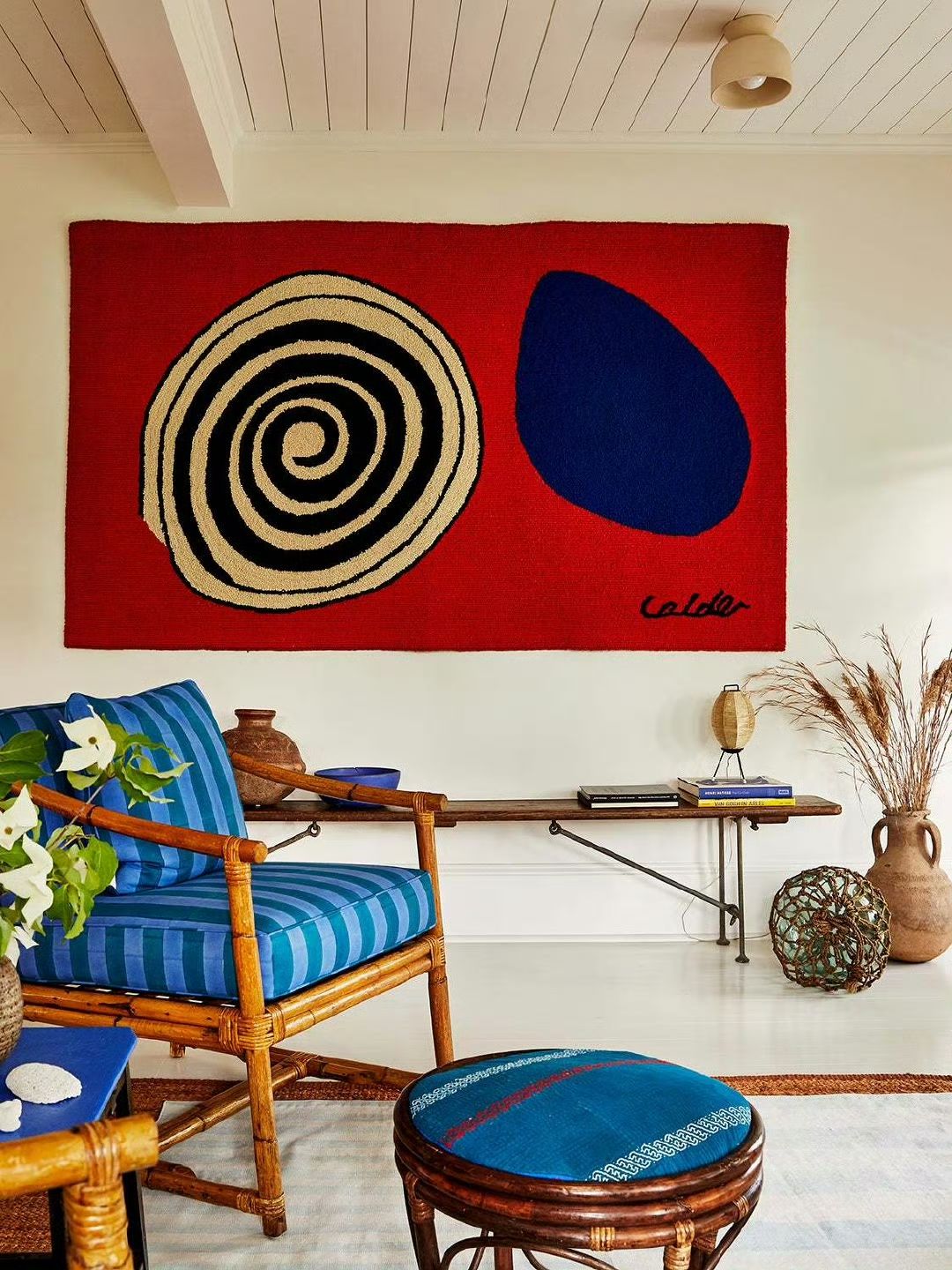 Calder tapestry with rattan furniture