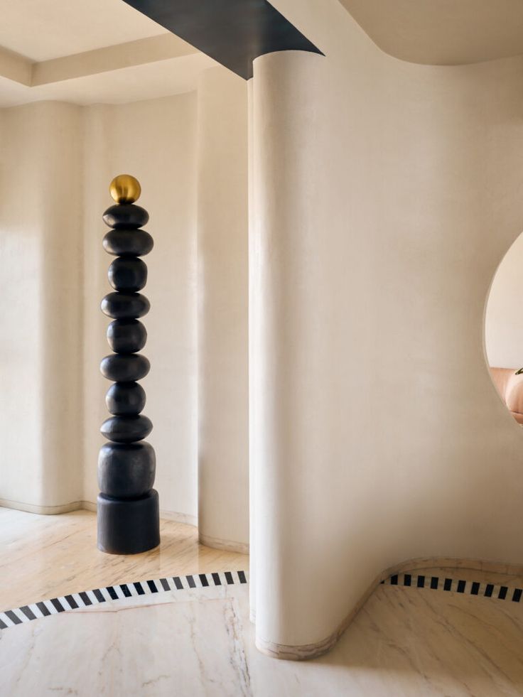 Black totem sculpture with gold