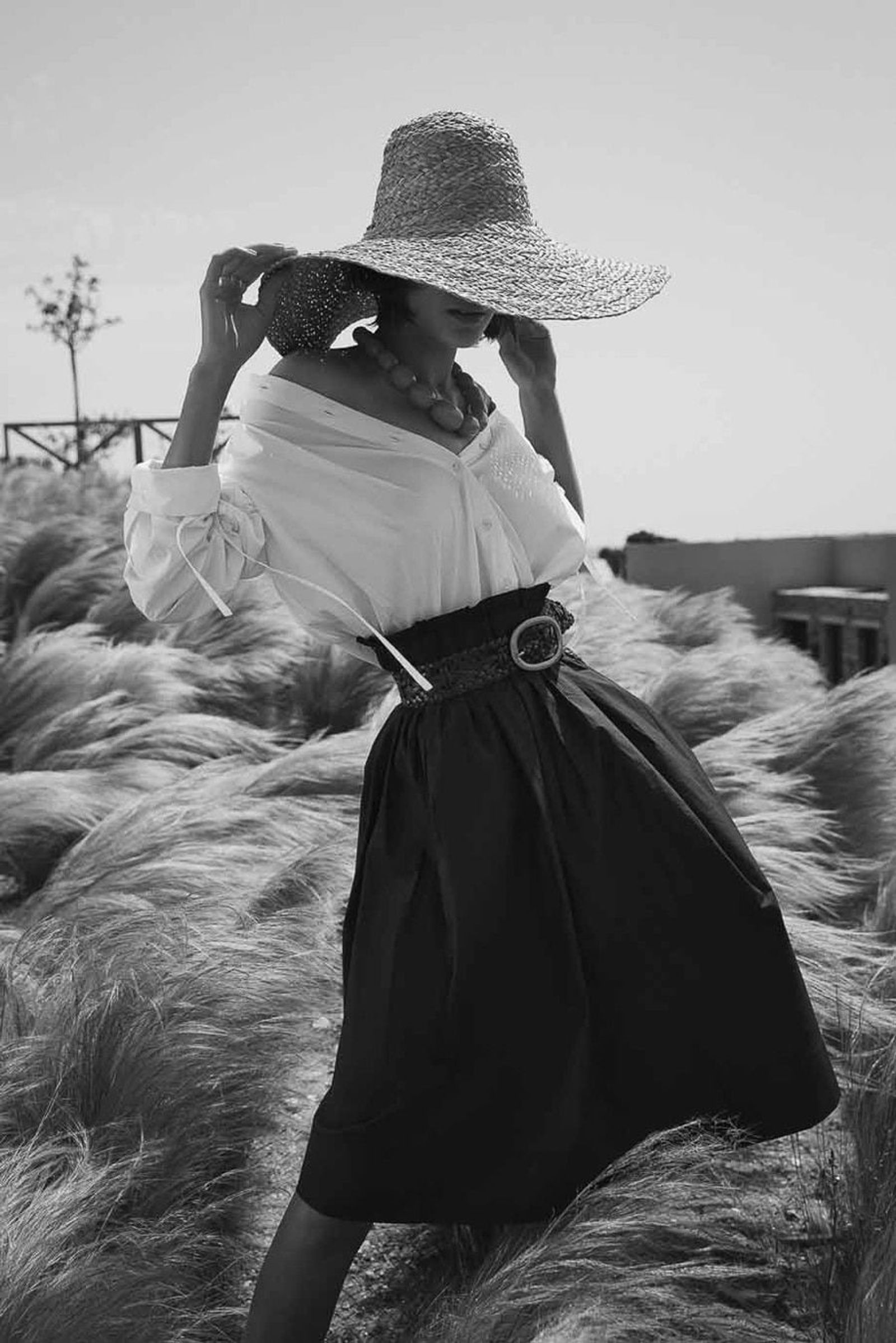 B&W editorial straw hat grasses