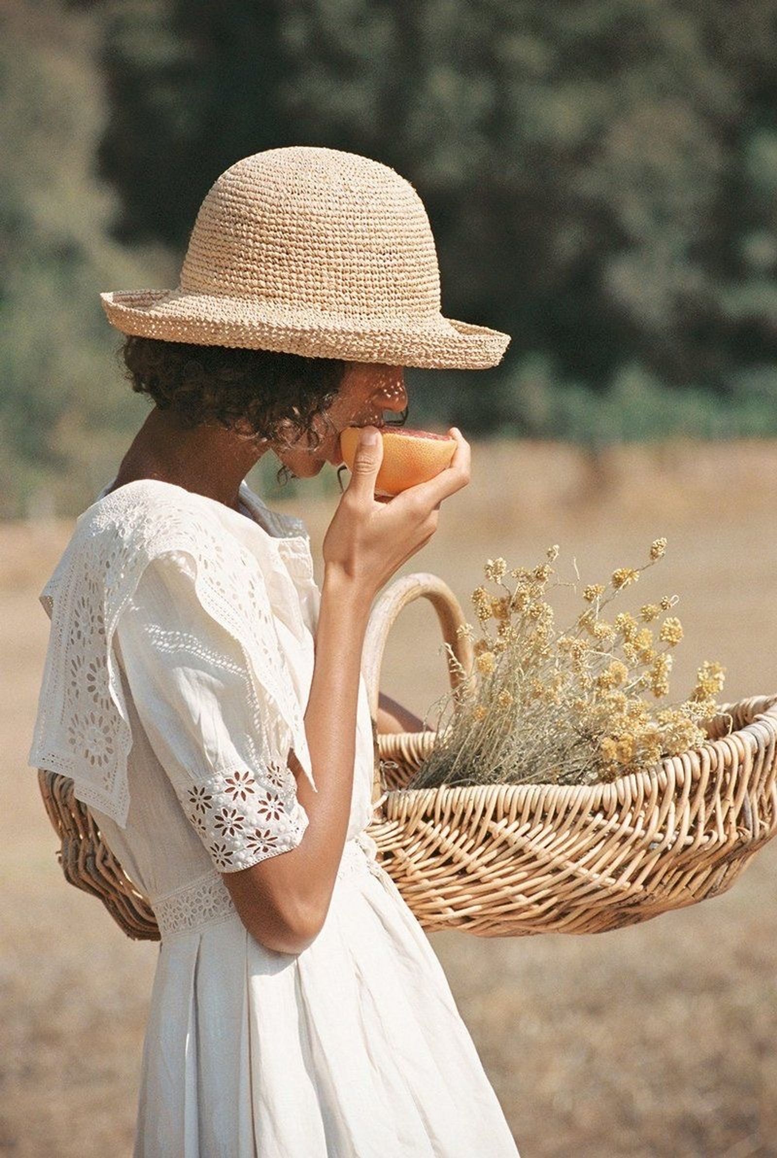 Woman with wicker basket and wildflowers