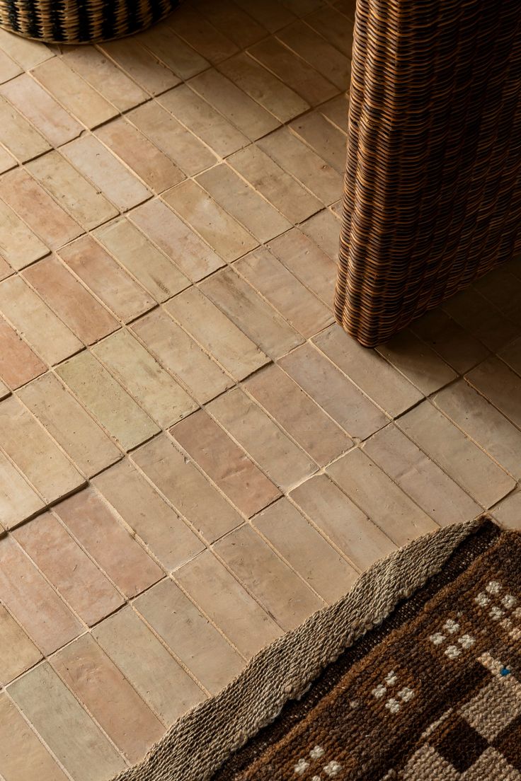 Handmade terracotta tiles with woven rug